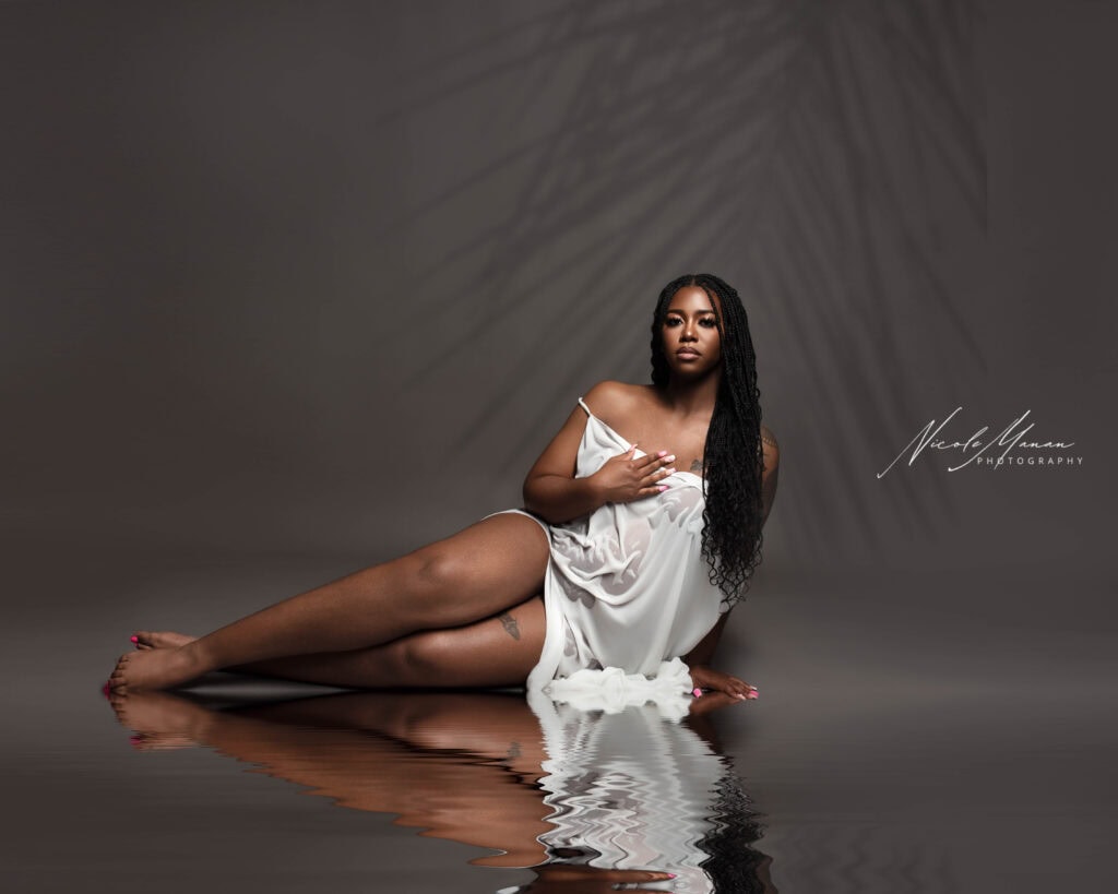 Elegant pregnant Black Woman Portrait in Water Reflection